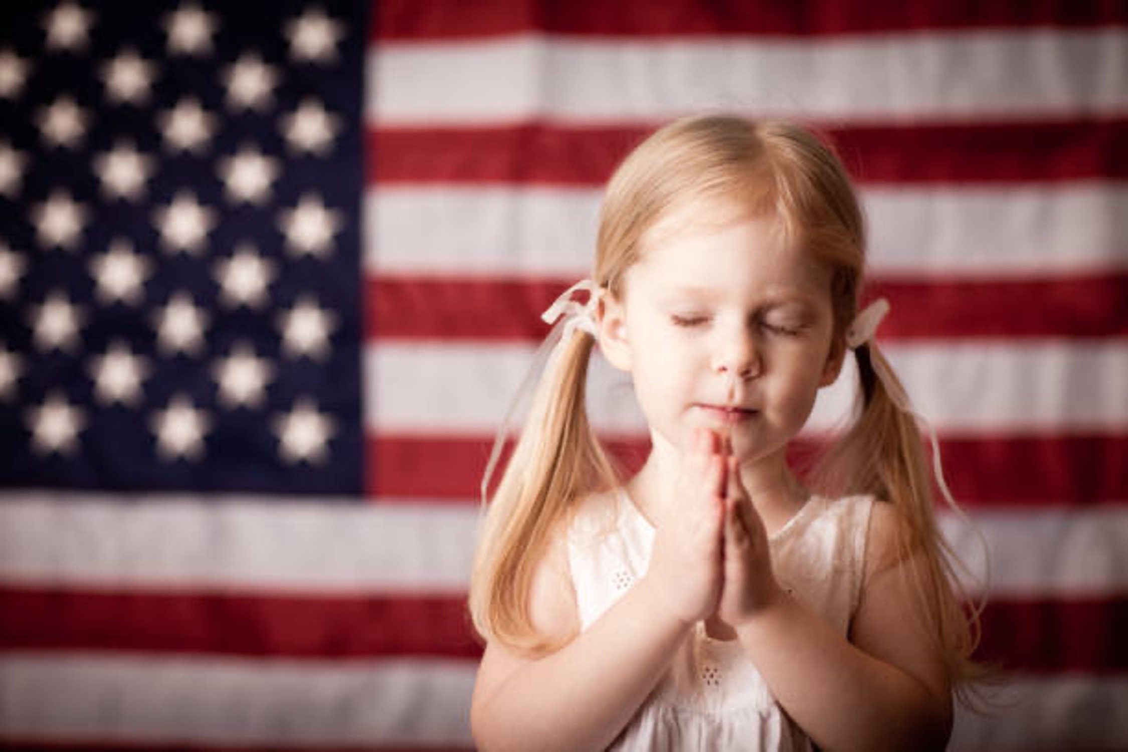 https://www.istockphoto.com/photo/little-girl-praying-in-front-of-american-flag-gm154961959-16365326?searchscope=image%2Cfilm